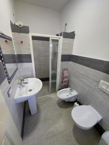 a bathroom with two sinks and a toilet at VILA MOZAIK in Kavajë +6 photos