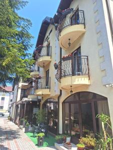 a building with balconies on the side of a street at Villa Una in Bihać