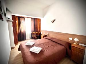 Posteľ alebo postele v izbe v ubytovaní Hotel Pinguino
