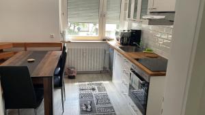 a kitchen with a counter and a sink and a table at WatzMannEG in Augsburg