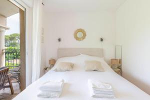 a bedroom with a white bed with two pillows at Exceptional 1-Bedroom Apartment 300m from Garoupe Beach Cap d’Antibes in Antibes +20 photos