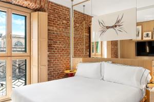 Postel nebo postele na pokoji v ubytování Hotel Milu Milano