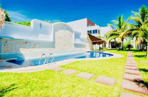 a house with a swimming pool in the yard at Playacar - Executive Budget Room With Swimming Pool Air Conditioning and Parking in Playa del Carmen