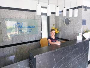 a woman sitting at a counter in an office at Fedasz Dental Szálláshely in Pilisvörösvár