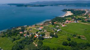 an aerial view of a village on the shore of a lake at Kampaoh Rianxo in Rianjo