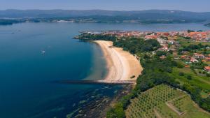 an aerial view of a beach and the ocean at Kampaoh Rianxo in Rianjo