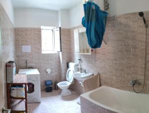 a bathroom with a tub and a toilet and a sink at Azizam hostel in Split