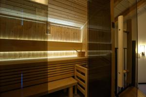 a bathroom with a sauna with a bench in it at Heritage Holiday Home Rafica 365 Wellness Retreat in Božava
