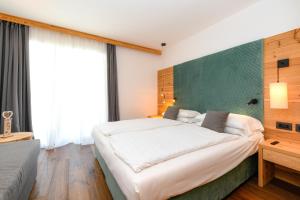 Voodi või voodid majutusasutuse Bepy Hotel Garni toas