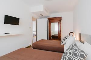 Łóżko lub łóżka w pokoju w obiekcie Suite Rosso & Nero - Lecce Selection