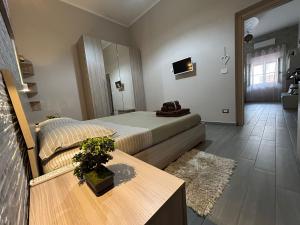 a bedroom with a bed and a table in a room at CAMARDA SUITE in Bernalda