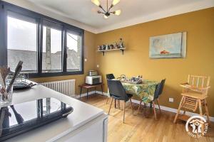 a kitchen and dining room with a table and chairs at Chez lili in Saint-Brieuc +24 photos