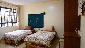Postel nebo postele na pokoji v ubytování ZZZ hostel Nairobi