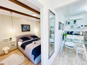 a bedroom with a bed and a desk in a room at Charming Seaside Apartment in Primošten