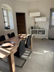 a dining room with a wooden table and chairs at Le Domaine du Château in Seynod