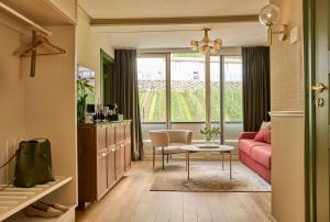 ein Wohnzimmer mit einem rosa Sofa und einem Tisch in der Unterkunft Hotel Ullensvang in Lofthus