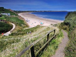 a view of a beach with people on the sand at Sands Lane Retreat - Cozy Bungalow in Hunmanby in Filey