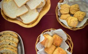 three baskets filled with bread and pastries on a table at Hosteria Del Pescador in Punta Del Diablo