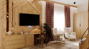 Televízia a/alebo spoločenská miestnosť v ubytovaní Hotel Jaworzyna Krynicka