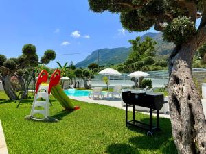 a bbq and a grill next to a pool at Villa GioEle - Pool & Relax in Mandra Capreria