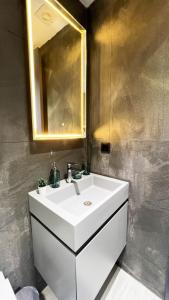 a bathroom with a white sink and a mirror at FOR LARGE FAMILIES, DUPLEX Vılla-305 in Cesme