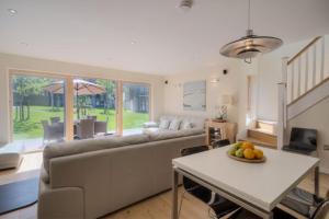 a living room with a couch and a table at House 2 in Looe