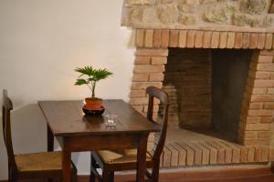 a table with a plant on it next to a brick fireplace at Nel cuore di Narni - ItalyWeGo in Narni +19 photos