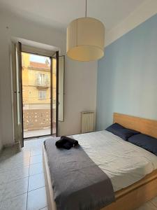a bedroom with a large bed and a large window at Blue House in Turin