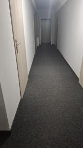 an empty hallway in an office building with a door at Gościniec 