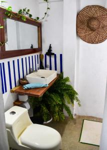 a bathroom with a sink and a toilet and a mirror at Habitacion Tiburon Ballena - Casa Tortuga in El Valle