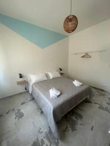 a bedroom with a bed with towels on it at DooR48 in Novara
