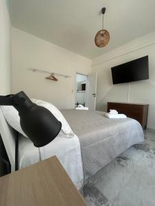 a bedroom with a bed and a black chair at DooR48 in Novara +34 photos