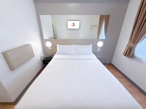 Postelja oz. postelje v sobi nastanitve Red Planet Ortigas