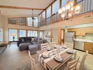 a kitchen and living room with a table and chairs at Lakefront 5BD/3BA/Dock/Firepit/Pet Friendly-17PP in Camdenton
