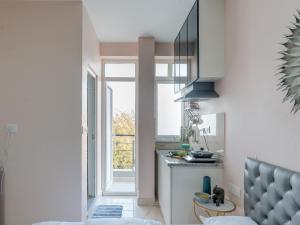 a kitchen with a sink and a window and a stove at Thamosa Stays in Jaipur