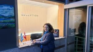 a woman standing in front of a reception desk at jasmine otel in Kemer