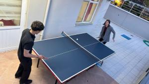 two people playing ping pong on a ping pong table at jasmine otel in Kemer