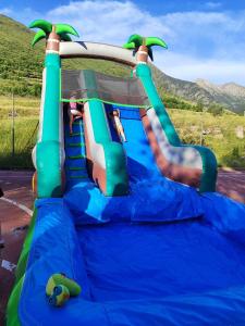 a blue and green inflatable slide in a playground at Aparthotel Siente Boí & SPA in Pla de l'Ermita