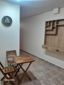 a table and a chair and a clock on a wall at Azur in Tamraght Ouzdar +32 photos