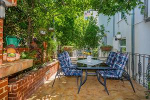 a patio with two chairs and a table on a balcony at Apartments Ružić in Split