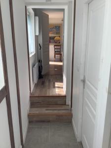 a hallway with stairs leading into a house at Longère au Numéro 7 in Le Tronquay