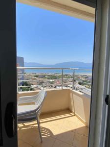 a chair on a balcony with a view of the ocean at penthouse with seaveiw in Vlorë
