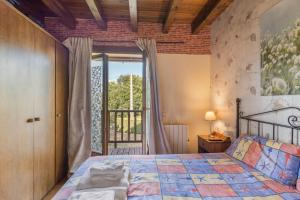 a bedroom with a bed and a large window at Can Vall Bellver in Bellver de Cerdanya 