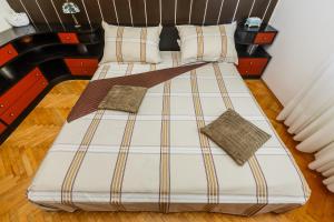 a double bed with two pillows on it at Apartments Ružić in Split