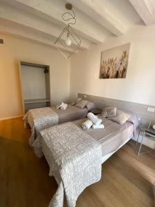 a bedroom with two beds and a painting on the wall at Room259 in Treviso