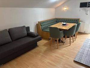 a living room with a couch and a table and chairs at Elgi Apart in Serfaus