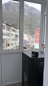 a room with two windows and a desk with a view at Cazare Herculane in Băile Herculane +6 photos