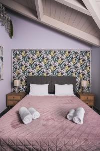 una camera da letto con un letto con due cuscini sopra di Casa di Voz Suites complex & free gym services by "elite" a Gaïtánion