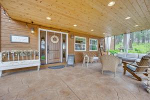 a porch of a house with a couch and chairs at CO Springs Apartment in the Pines with Treehouse! in Gleneagle