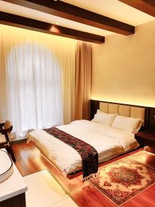 Postel nebo postele na pokoji v ubytování Kashgar QIu Ge Homestay